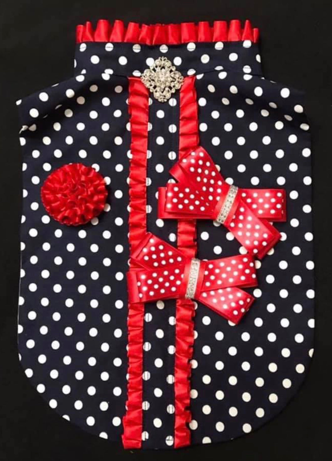Bib in navy with white spots and red trim